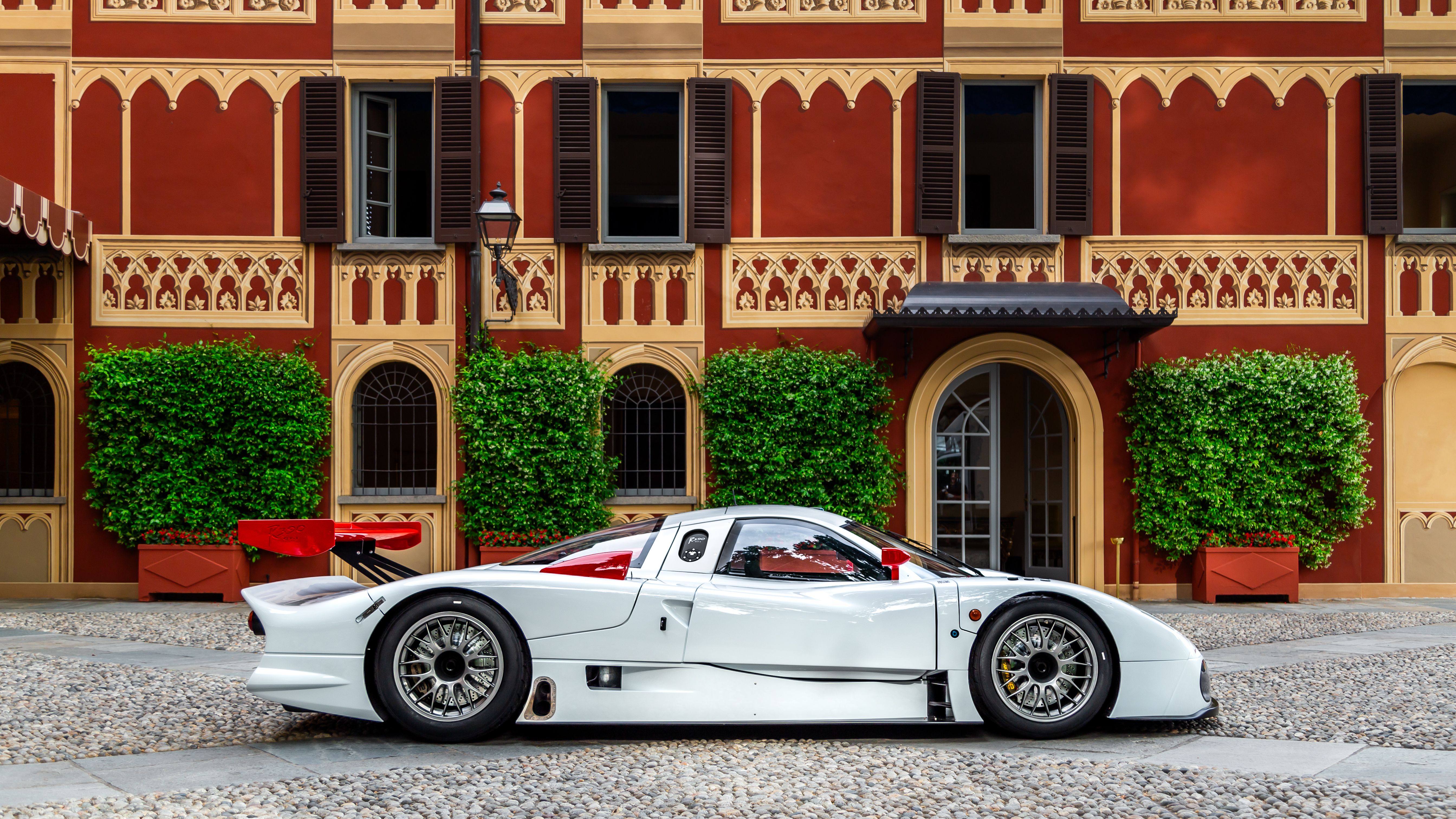 Nissan R390 GT1 side profile parked in front of an old building